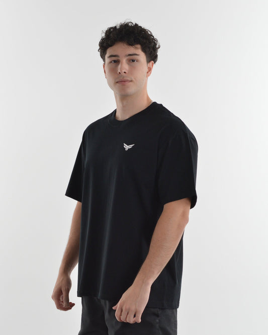 Person wearing a black t-shirt with a logo on a white background
