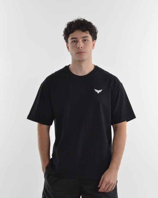 Person wearing a black t-shirt with a logo on a white background