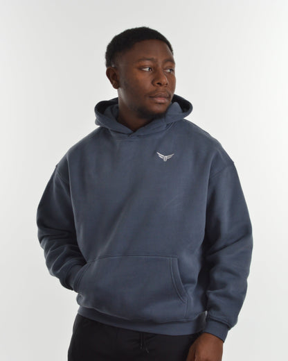 Person wearing a blue hoodie with a logo on a white background