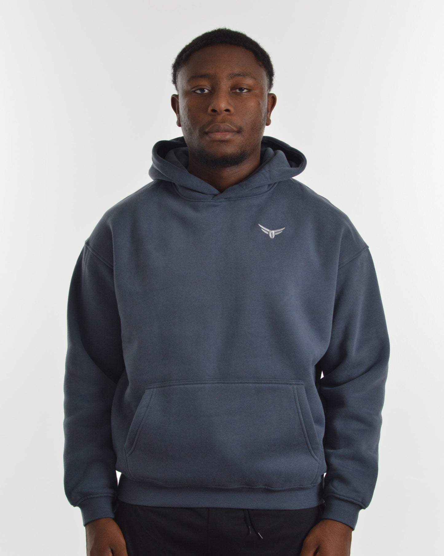 Person wearing a blue hoodie with a logo on a white background