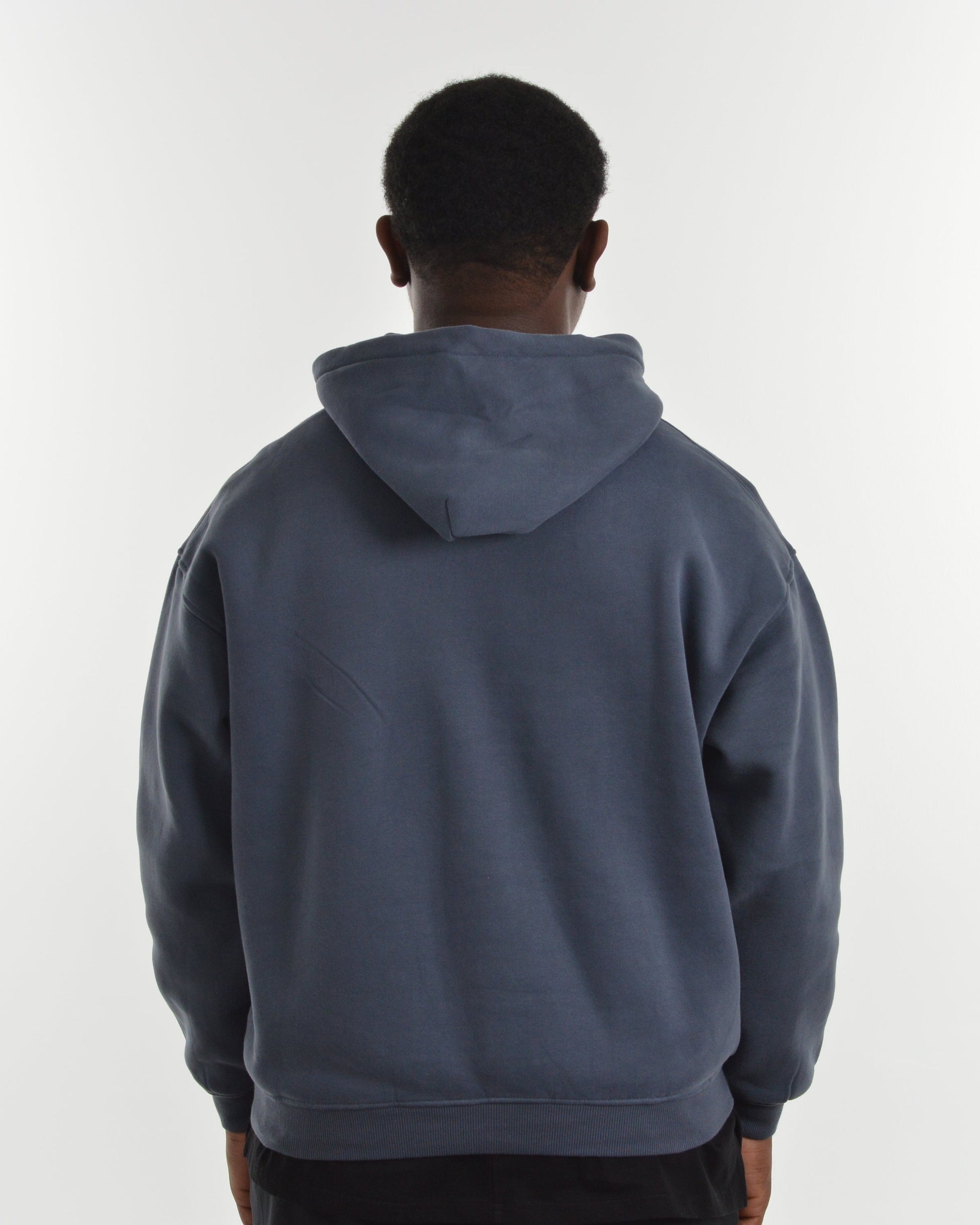 Person wearing a blue hoodie from behind on a white background
