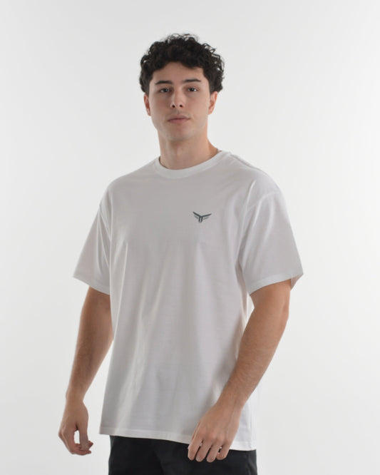 Person wearing a light gray t-shirt with a small logo on a white background