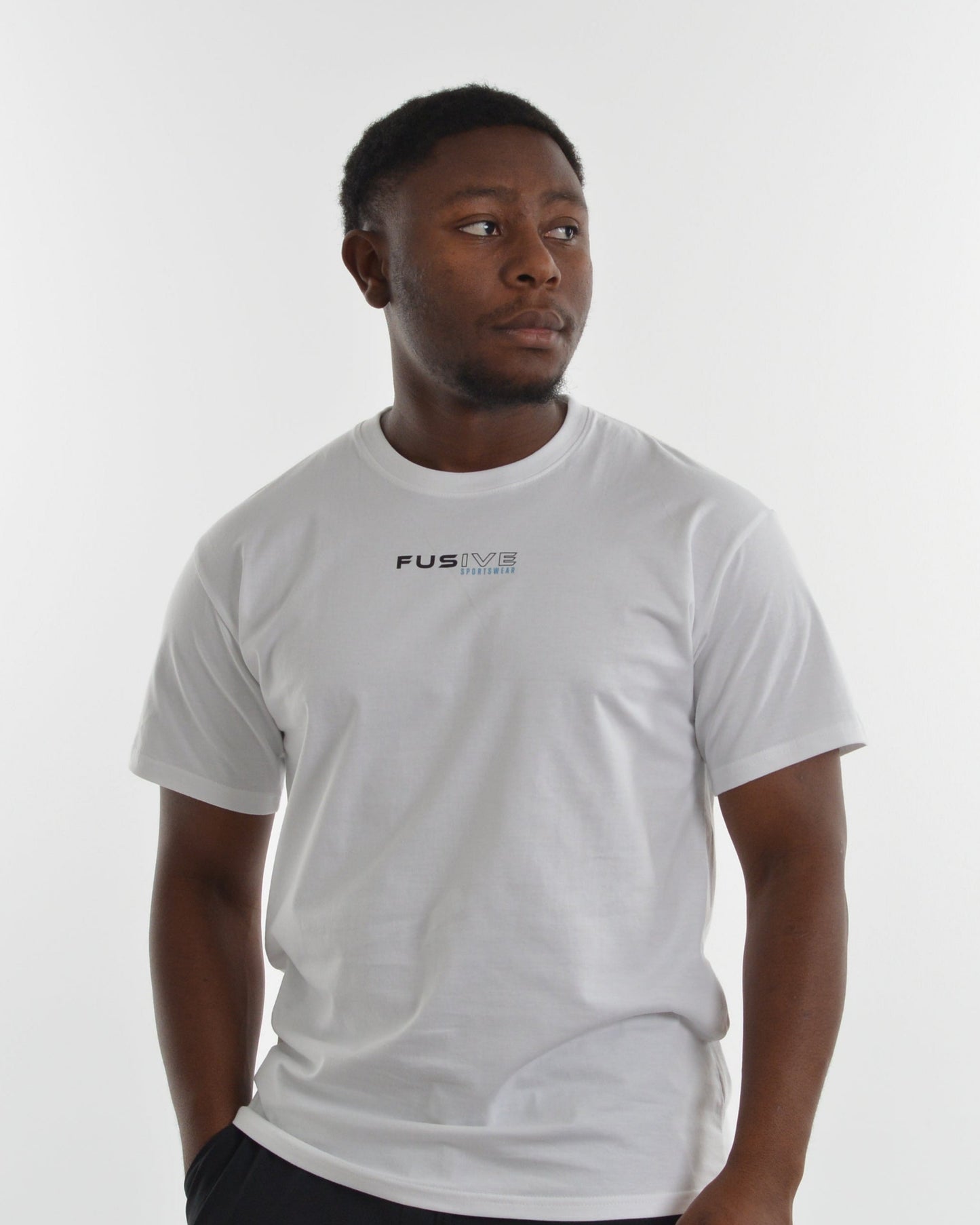 Person wearing a white t-shirt with a logo on a plain background