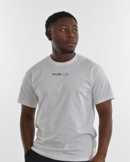Person wearing a white t-shirt with a logo on a plain background