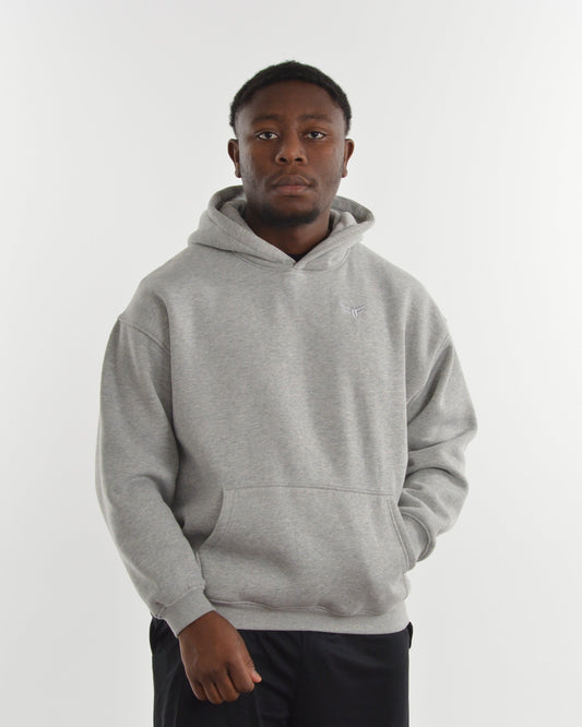 Person wearing a gray hoodie on a white background