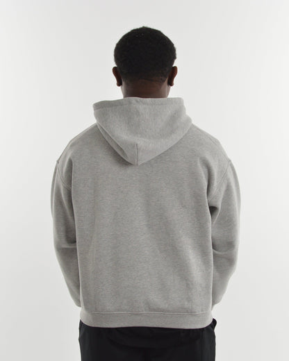 Person wearing a gray hoodie from behind on a white background