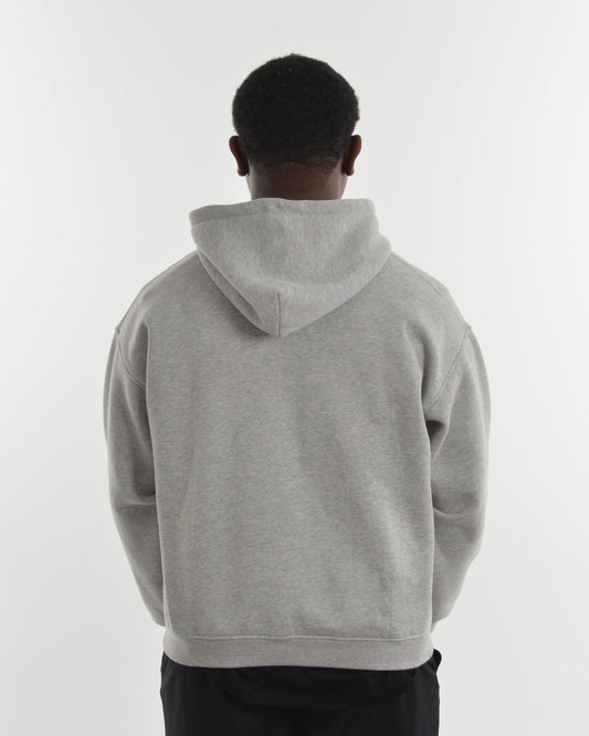Person wearing a gray hoodie from behind on a white background