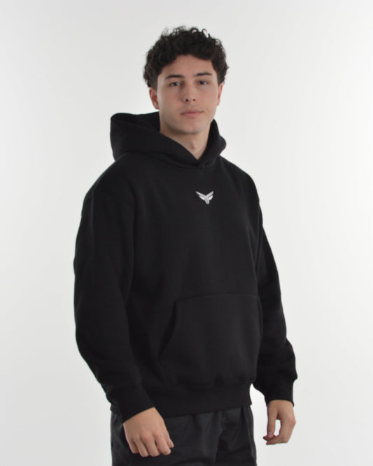 Person wearing a black hoodie with a logo on a white background